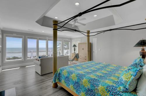 a bedroom with a bed and a view of the ocean at 910 Ocean Boulevard in Isle of Palms
