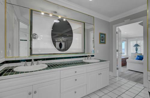 a bathroom with two sinks and a large mirror at 910 Ocean Boulevard in Isle of Palms