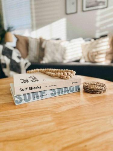 a book sitting on top of a wooden table at Cozy Coastal Bungalow in Opelika