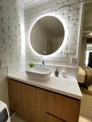 a bathroom with a sink and a mirror at Sailz Villas in Yarrawonga