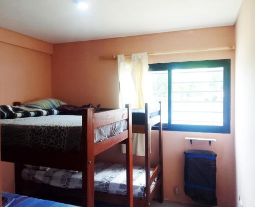 ein Schlafzimmer mit einem Etagenbett und einem Fenster in der Unterkunft House, Summer in Villa Gesell
