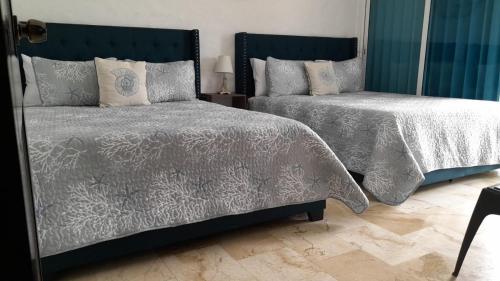 Ein Bett oder Betten in einem Zimmer der Unterkunft Terrazas del Mar II - Ocean View Apartment