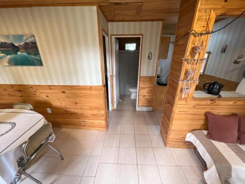 a room with a hospital bed and a hallway at Cabaña Terra Calma in Vistalba