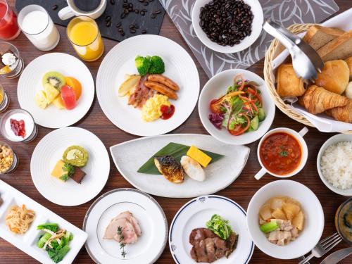 a table with white plates of food on it at The OneFive Sendai in Sendai