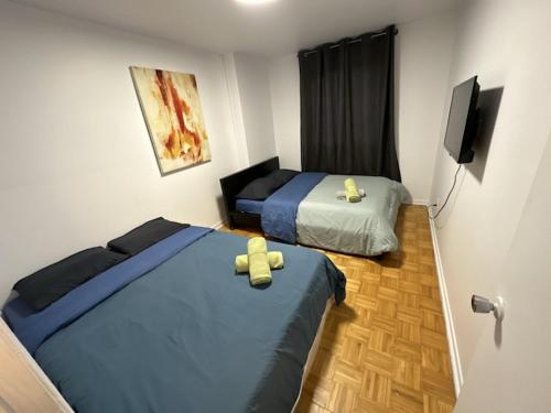 a room with two beds and a television in it at 1 bedroom apartment - 574 in Montréal