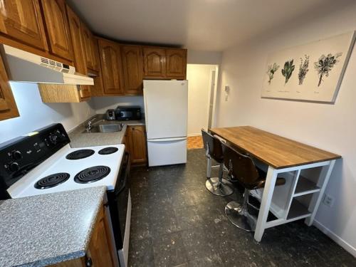 a kitchen with a stove and a white refrigerator at 1 bedroom apartment - 574 in Montréal