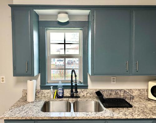 a kitchen counter with a sink and a window at Comfy Home With Gated Garden I Family Reunion in Oklahoma City