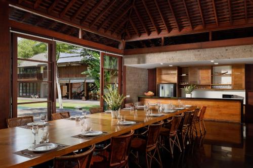 a large dining room with a long table and chairs at Villa Amita by Nakula in Kerobokan