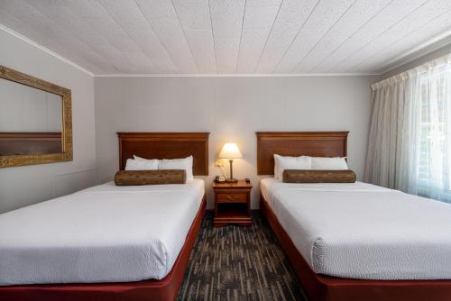 a hotel room with two beds and a window at Scotty's Lakeside Resort in Lake George