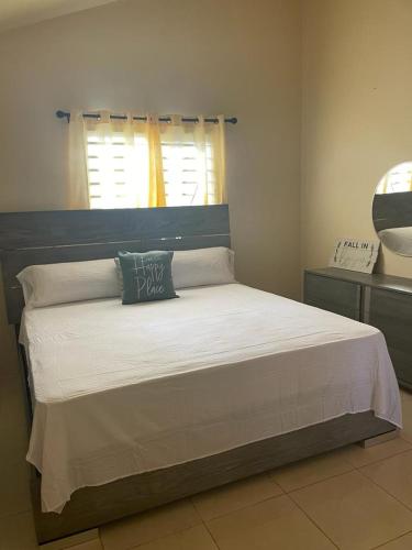 ein Schlafzimmer mit einem Bett mit einem Kissen darauf in der Unterkunft Finest Accommodation Lot 1577 Phoenix Park Phase 4 Portmore St Catherine 
