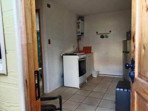 a small kitchen with a sink and a stove at Ruta 7 in Coihaique