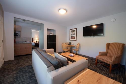 a living room with a couch and a table at Scotty's Lakeside Resort in Lake George