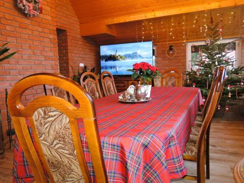 a dining room with a table and a television at Holiday Home Ko czewo near Lakes and Forests in Kołczewo
