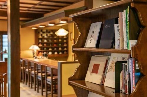 a row of books on shelves in a wine cellar at 岩井温泉　岩井屋 in Iwamicho