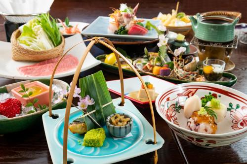 a table with many plates of food on it at 岩井温泉　岩井屋 in Iwamicho