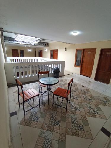 a room with a table and two chairs and a table at The Swarna Hotel Bayah Lebak in Muaramadur