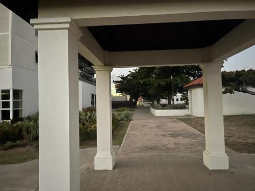 a large white pavilion in front of a building at Finest Accommodation Apt #408 Bayfront Villa Portmore St Catherine in Portmore