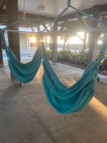a blue hammock hanging from a building at Endless Summer Beach House in Myrtle Beach