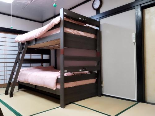 a bunk bed room with two bunk beds in it at HILDA INN in Kashiwa