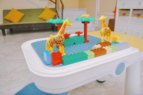 two toy giraffes on a table in a room at The Swarna Hotel Bayah Lebak in Muaramadur