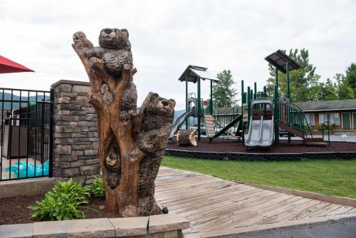 a statue of two bears in a playground at Scotty's Lakeside Resort in Lake George