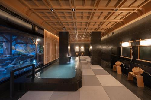 a hallway with an indoor pool in a building at Maruyama Onsen Kojyokan in Minami Uonuma