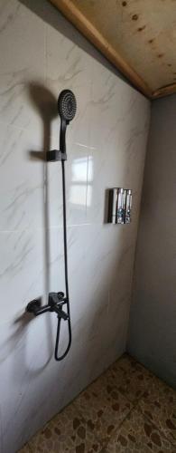 a shower in the corner of a room at Amanya 3-Bedroom Hut Amboseli in Amboseli