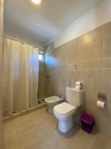 a bathroom with a toilet and a shower at Sunset Village in Villa Carlos Paz