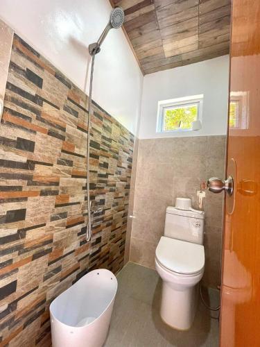a bathroom with a toilet and a shower at A-House Beachfront in Bootin