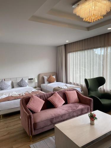 a living room with a couch and a bed at The Willow Phangan in Koh Phangan