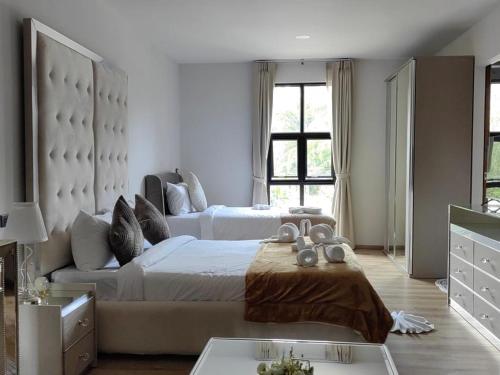 a large bedroom with two beds and a couch at The Willow Phangan in Koh Phangan
