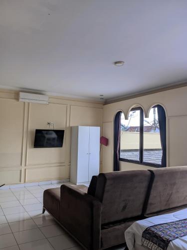 a living room with a couch and a window at The Swarna Hotel Bayah Lebak in Muaramadur