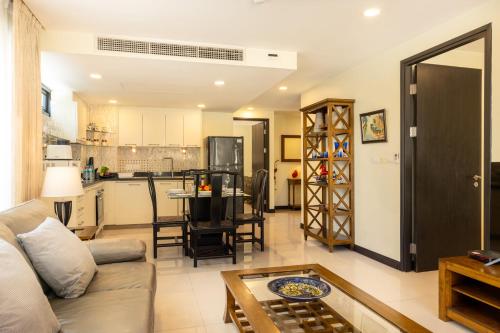 a living room with a couch and a table at Citismart Luxury Apartments in Pattaya Central