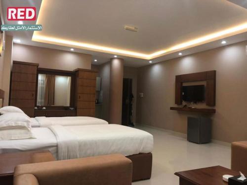 Postel nebo postele na pokoji v ubytování RED-5 - AL Safa Suites