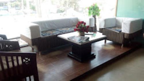 a living room with a couch and a coffee table at Hotel Mahal Inn,Amritsar in Amritsar