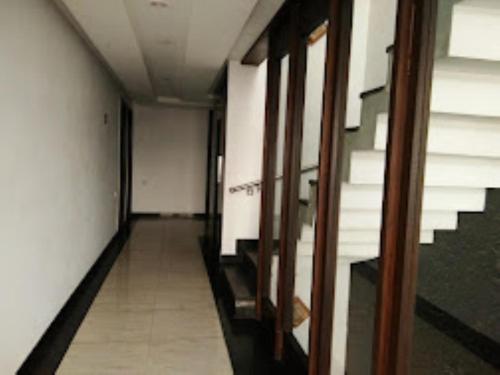 an empty hallway with stairs in a building at Hotel Mahal Inn,Amritsar in Amritsar