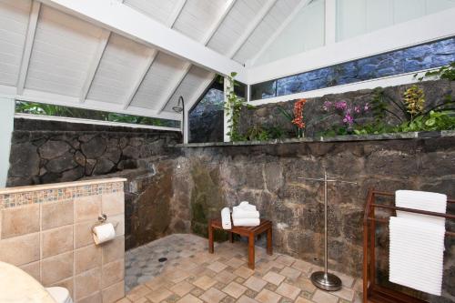 a bathroom with a shower and a bench in it at Hale Kainalu in Kailua