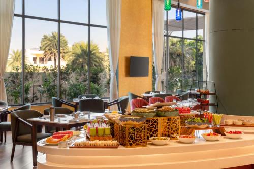a buffet of food on a table in a restaurant at Ramada Encore by Wyndham Amritsar Airport in Amritsar