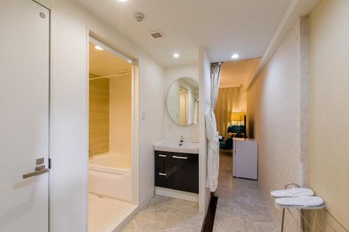 a bathroom with a sink and a shower at Himalaya Cloud Hotel in Tokyo