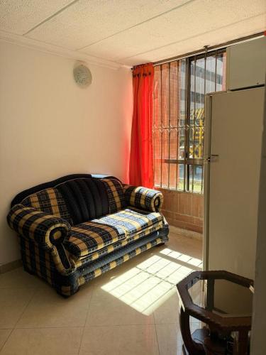 a living room with a couch and a window at Apartamento Ciudad Salitre Bogota - Amoblado in Bogotá