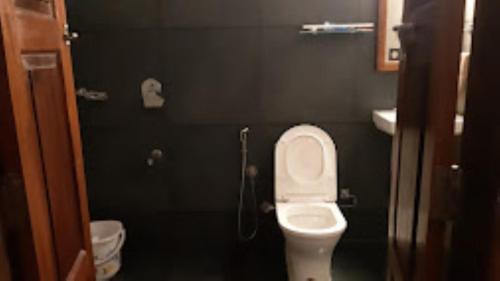 a small bathroom with a toilet and a sink at THE PAMBA HERITAGE VILLA Nedumudy in Champakulam