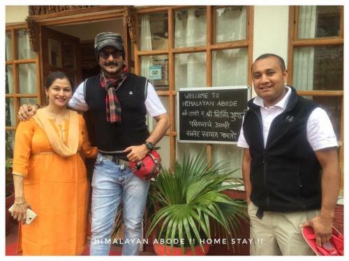 a woman and two men standing in front of a building at Himalayan Abode Joshimath in Joshīmath