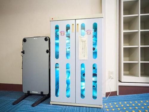 a locker with blue snowboards on a wall at Okasan Hotel - Vacation STAY 77675v in Ogaki