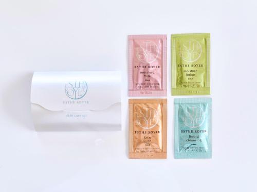 a group of four bottles of soap on a white background at Okasan Hotel - Vacation STAY 77675v in Ogaki