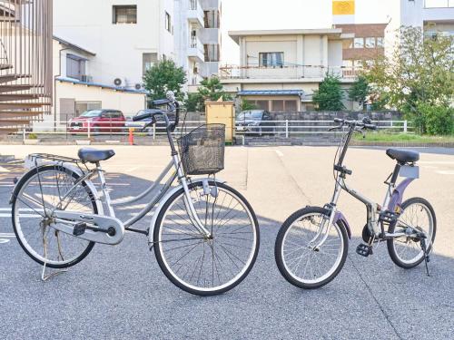 two bikes parked next to each other on a street at Okasan Hotel - Vacation STAY 77675v in Ogaki