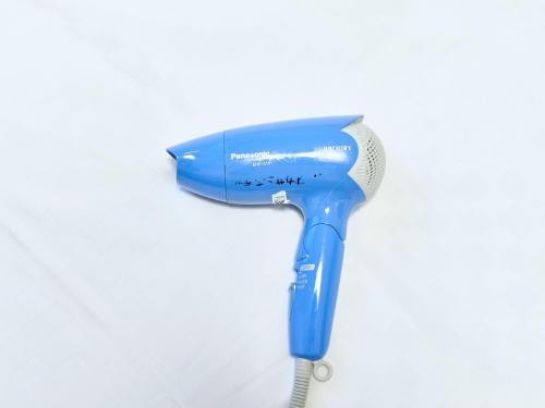 a blue blow dryer on a white background at Okasan Hotel - Vacation STAY 77675v in Ogaki