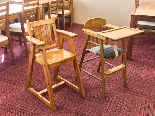 two wooden chairs and a table in a room at Okasan Hotel - Vacation STAY 77675v in Ogaki