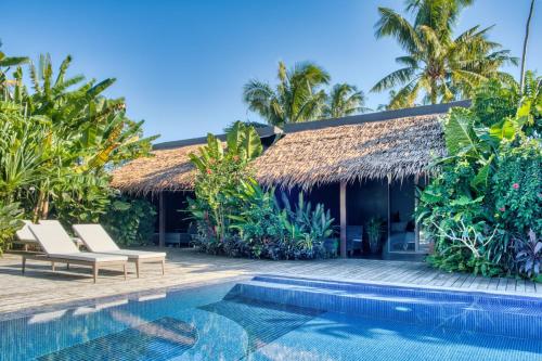 a villa with a swimming pool and a resort at Kajali Siargao in General Luna