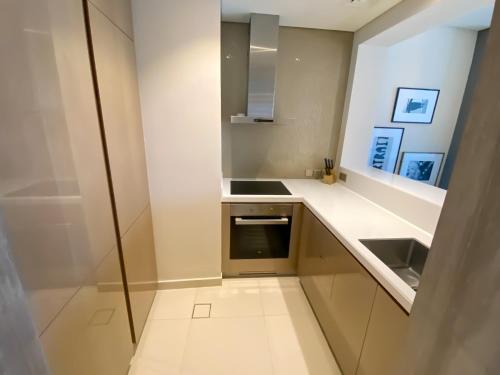 a small kitchen with a sink and a stove at AMAZNING VIEW & PARAMOUNT BRANDED TWO BEDROOM APARTMENTS BRUJ VIEW in Dubai