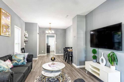a living room with a couch and a tv at HOUSE WITH FREE PARKING in Lorain
